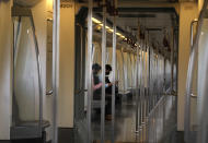 Commuters travel in an almost empty Delhi metro train in New Delhi, India, Monday, Sept. 7, 2020. India's coronavirus cases are now the second-highest in the world and only behind the United States, as the caseload crosses Brazil on a day when urban metro trains partially resume service in the capital New Delhi and other states. (AP Photo/Manish Swarup)