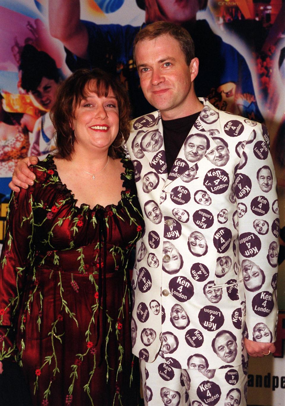 Comic Harry Enfield and co-star Kathy Burke arriving at the World Charity Premiere of their film 'Kevin and Perry Go Large' in aid of Comic Relief, which was screened at the Warner Village West End in London's Leicester Square.  * Enfield turned up in an outfit emblazoned with his support for London mayoral candidate Ken Livingstone, the latest showbiz star to pledge allegiance to Mr Livingstone.   (Photo by Tony Harris - PA Images/PA Images via Getty Images)