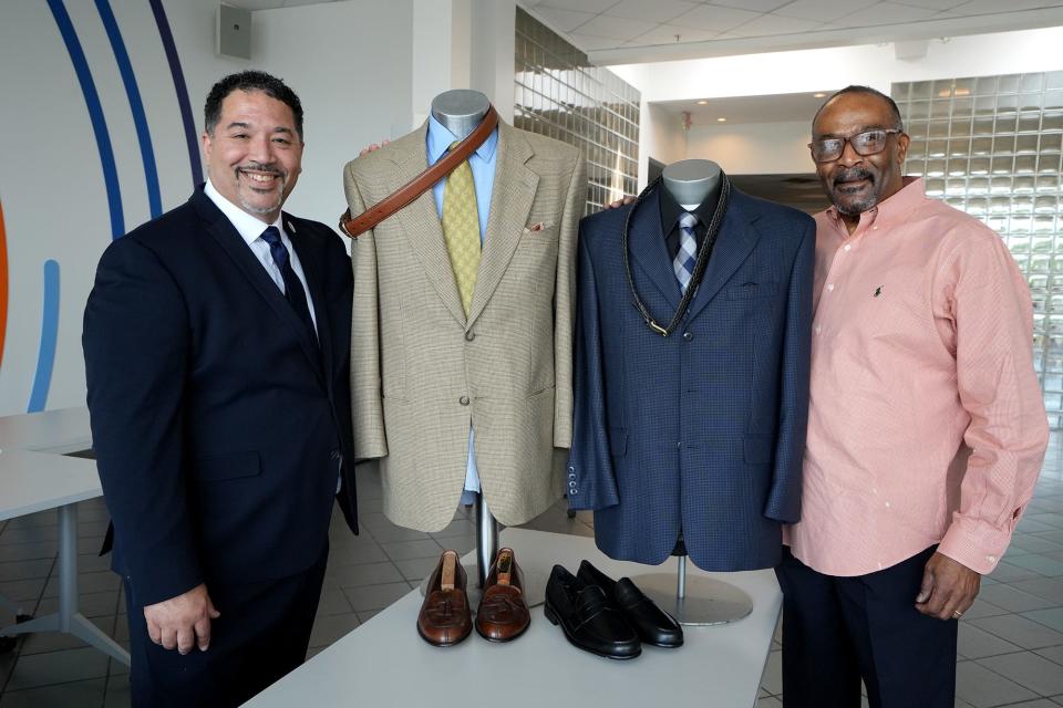 Impact Community Action CEO Robert "Bo" Chilton, left, and Nehemiah House of Refuge Executive Director Terry Byrd, right, pose with professional menswear on May 12, at the Otto Beatty Jr. Men's Shop. The Franklin County Board of Commissioners unanimously approved Tuesday giving $330,766 in federal COVID relief funds to the shop, which provides low-income men with a professional wardrobe and other services. The longtime state lawmaker, attorney for Impact and late husband of U.S. Rep. Joyce Beatty donated a sizeable amount of his professional wardrobe.