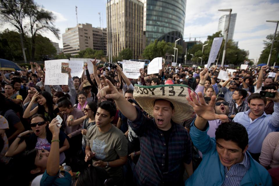 Students shout slogans during to protest a possible return of the old ruling Institutional Revolutionary Party (PRI) in Mexico City, Wednesday, May 23, 2012. Demonstrators also protested against what students perceive as a biased coverage by major Mexican TV networks of the presidential elections campaign, which they claim to be directed in favor of PRI's candidate Enrique Pena Nieto. Mexico will hold presidential elections on July 1. (AP Photo/Eduardo Verdugo)