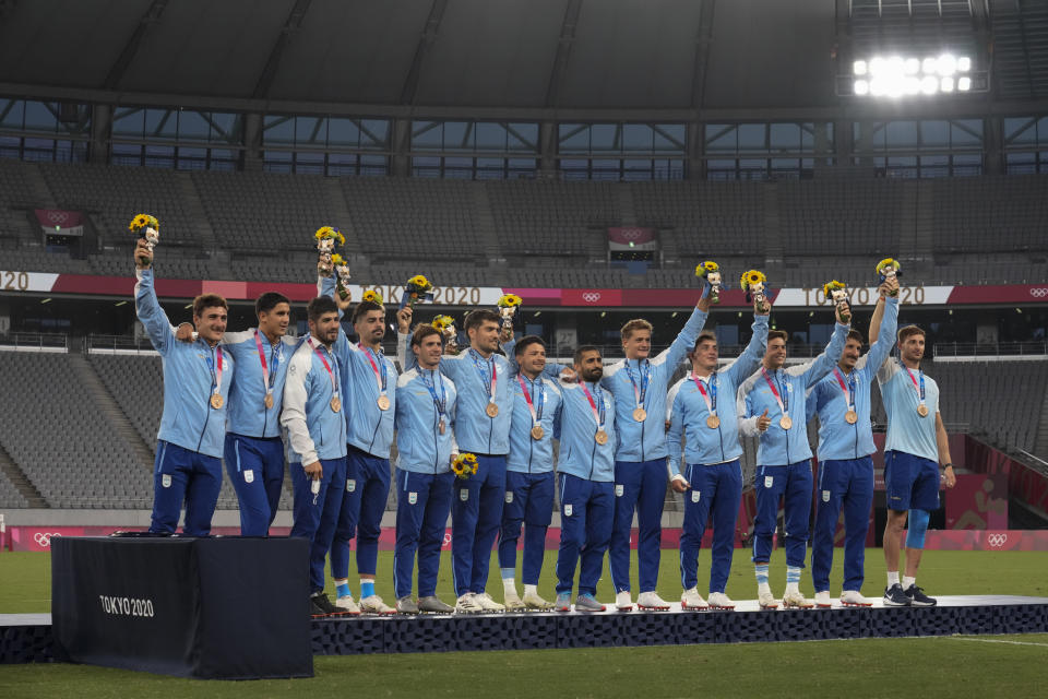 CORRECTS TO BRONZE FROM SILVER - Argentina players celebrate on the podium wearing their bronze medals in men's rugby sevens, at the 2020 Summer Olympics, Wednesday, July 28, 2021 in Tokyo, Japan. (AP Photo/Shuji Kajiyama)