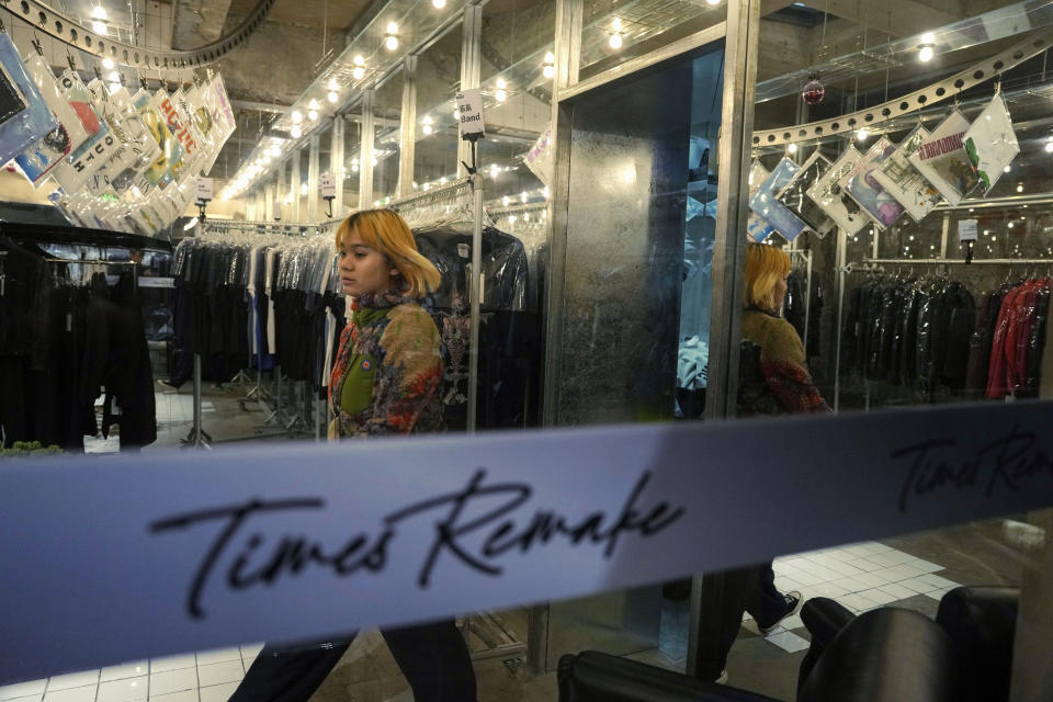 A worker walks around in a store for Times Remake, a Shanghai-based brand that takes secondhand clothes and refashions them into new garments in Shanghai on March 18, 2024. (AP Photo/Ng Han Guan)