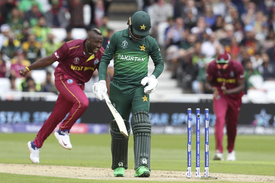 Pakistan's Shadab Khan walks off the field, bowled by West Indies' Andre Russell, during their Cricket World Cup match at Trent Bridge cricket ground in Nottingham, England, Friday, May 31, 2019. (AP Photo/Rui Vieira)