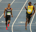 Usain Bolt wags a finger at Andre de Grasse after de Grasse challenges him towards the end of the Men’s 200m Semifinals.