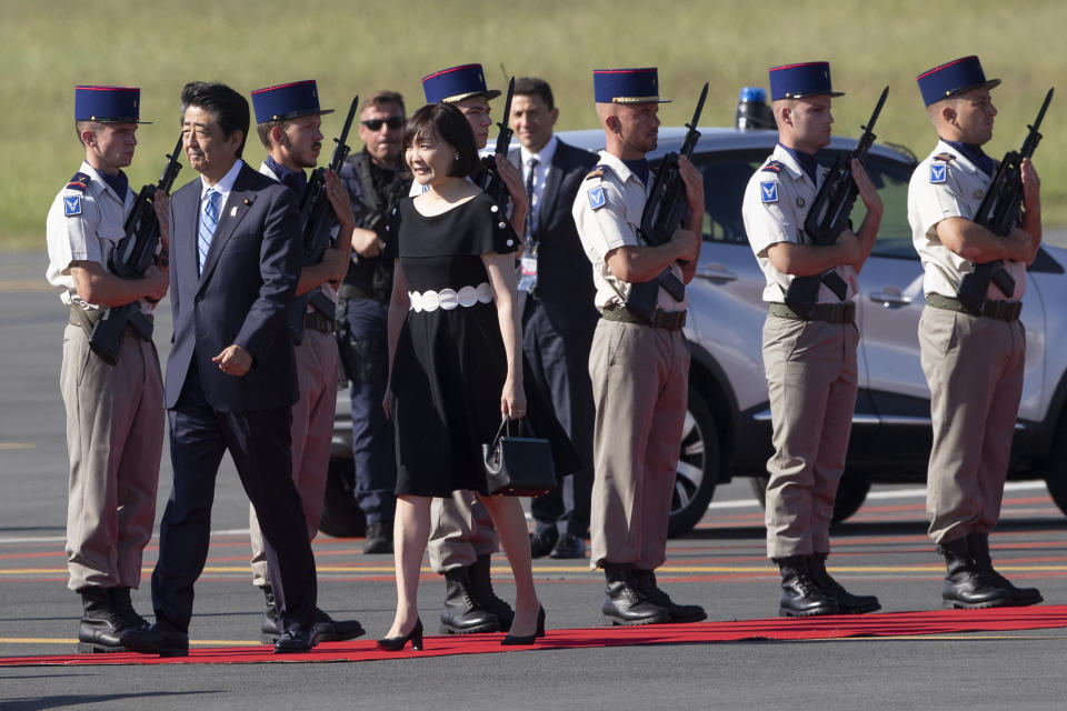 Japanese Prime Minister Shinzo Abe and his wife Akie Abe arrive at the airport in Biarritz, France, for the first day of the G-7 summit, Saturday, Aug. 24, 2019. U.S. President Donald Trump and the six other leaders of the Group of Seven nations will begin meeting Saturday for three days in the southwestern French resort town of Biarritz. France holds the 2019 presidency of the G-7, which also includes Britain, Canada, Germany, Italy and Japan. (AP Photo/Peter Dejong)