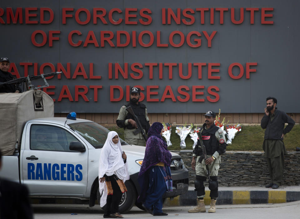 Troops of the Pakistani paramilitary forces stand alert as security is beefed up outside the Armed Forces Institute of Cardiology where Pakistan's former president and military ruler Pervez Musharraf is admitted in Rawalpindi, Pakistan, Friday, Jan. 3, 2014. Musharraf was rushed to a hospital on Thursday with a heart problem he experienced while on his way to a court hearing in the high treason case, police and lawyers said. (AP Photo/B.K. Bangash)