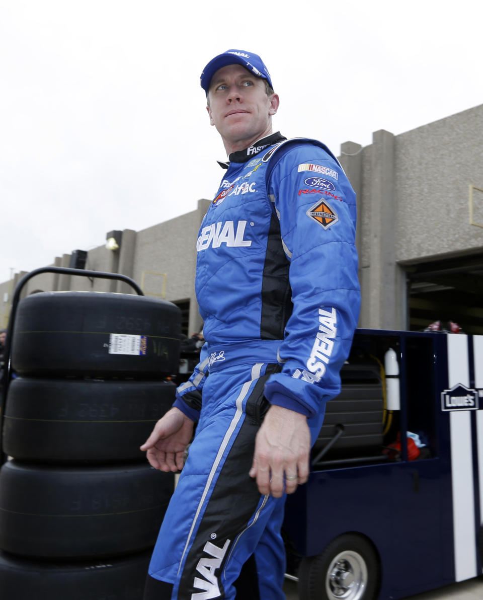 Carl Edwards leaves the garage heading to his trailer after a practice session for the NASCAR Sprint Cup Series auto race at Texas Motor Speedway in Fort Worth, Texas, Saturday, April 5, 2014. (AP Photo/LM Otero)