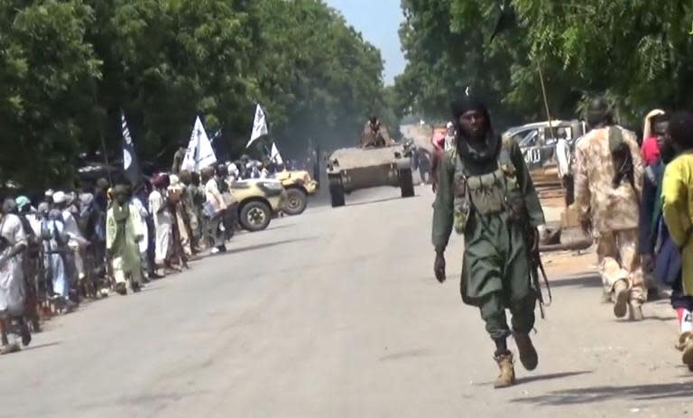 Boko Haram fighters parade with a tank through an unidentified town in Nigeria in this screengrab taken on November 9, 2014 from a new video released by the militant group