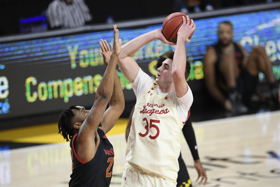 Wisconsin forward Nate Reuvers (35) shoots against Maryland forward Donta Scott during the first half of an NCAA college basketball game Wednesday, Jan. 27, 2021, in College Park, Md. (AP Photo/Nick Wass)