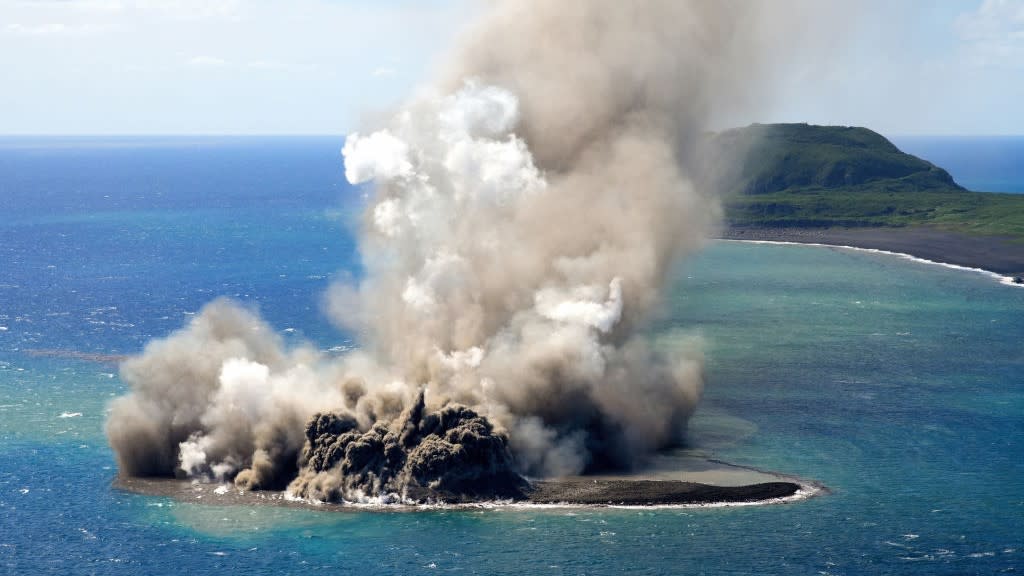 A aerial view of the new island and its eruption plume.