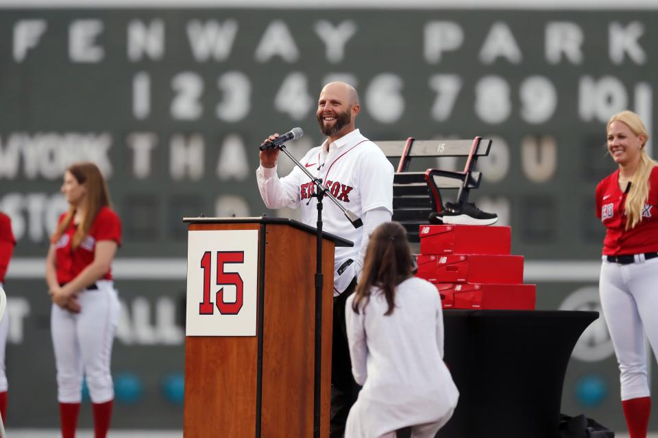 Former Boston Red Sox's Dustin Pedroia, center, addresses fans during ceremonies in his honor before a baseball game against the New York Yankees, Friday, June 25, 2021, in Boston. (AP Photo/Michael Dwyer)