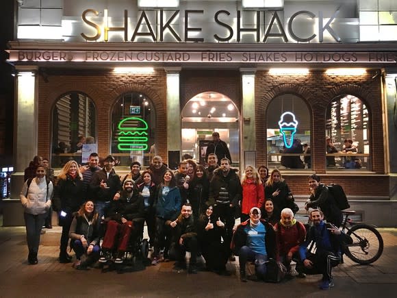 About two dozen people outside a Shake Shack location.