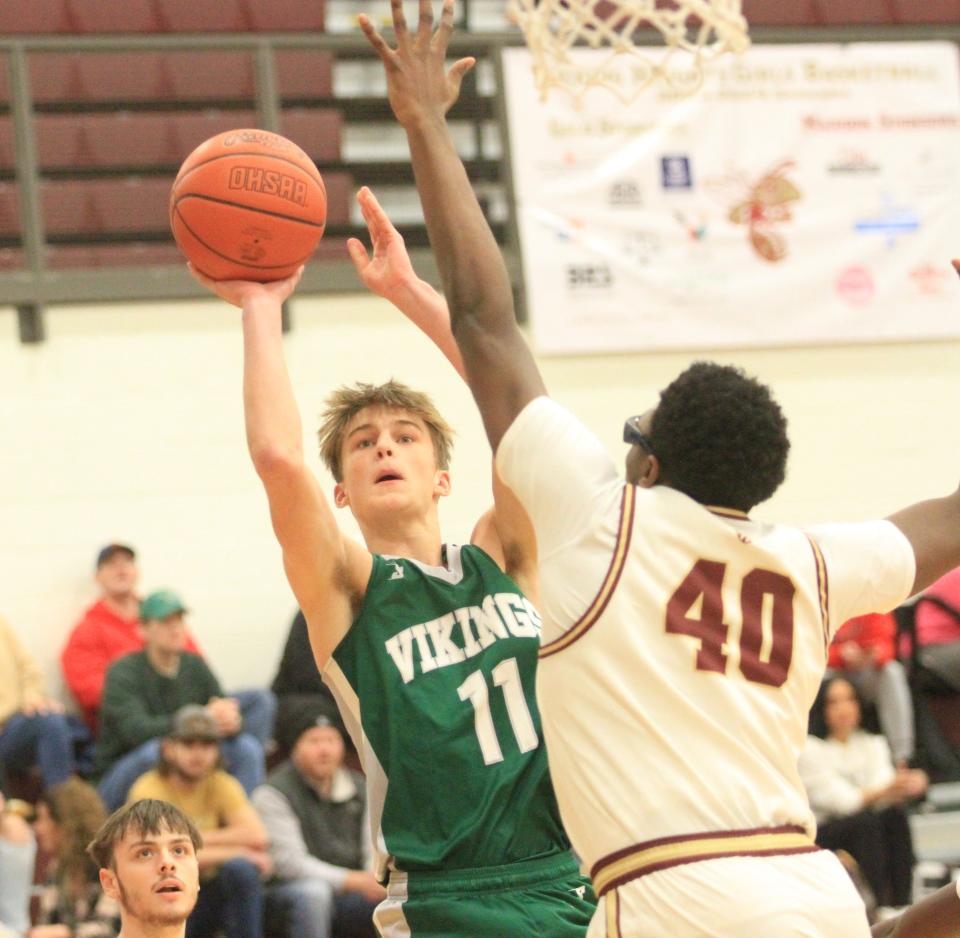 Northridge's Carter Mallernee shoots over Licking Heights' Nate Lovinsky on Jan. 10.