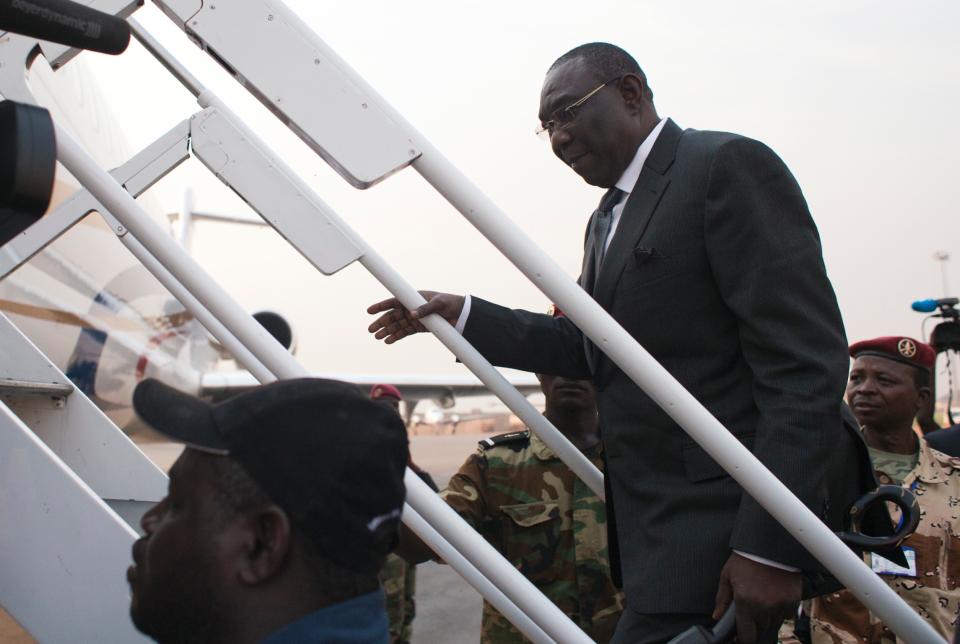 Central African Republic President Michel Djotodia boards a plane to Chad, at Mpoko Airport in Bangui, Central African Republic, Wednesday, Jan. 8, 2014. The embattled president, who has come under growing pressure to resign, traveled to neighboring Chad on Wednesday for a summit with regional leaders who want to end the bloodshed that has left more than 1,000 dead and nearly a million people displaced.(AP Photo/Rebecca Blackwell)