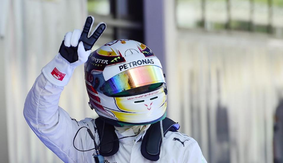 Mercedes driver Lewis Hamilton of Britain gestures after setting the pole position in the qualifying session ahead of the Spain Formula One Grand Prix at the Barcelona Catalunya racetrack in Montmelo, near Barcelona, Spain, Saturday, May 10, 2014. Lewis Hamilton earned his fourth pole position of the Formula One season Saturday as Mercedes was again in a class of its own in qualifying for the Spanish Grand Prix, while four-time champion Sebastian Vettel was left stranded by his faulty Red Bull. Hamilton clocked a leading lap of 1 minute, 25.232 seconds on the Barcelona-Catalunya circuit for his 35th career pole. (AP Photo/Manu Fernandez)