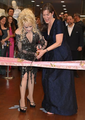 <p>AFF-USA/Shutterstock </p> Dolly Parton and Lipscomb University President Candice McQueen cut the ribbon at 'Dolly Parton & the Makers: My Life in Rhinestones'