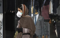 A woman walks as she wears a mask in downtown Tehran, Iran, Thursday, Feb. 27, 2020. Amid fear and uncertainty caused by the spread of a new virus, Iranians are taking extra caution to avoid getting infected, as authorities canceled Friday prayers in Tehran, Qom and other cities. (AP Photo/Vahid Salemi)