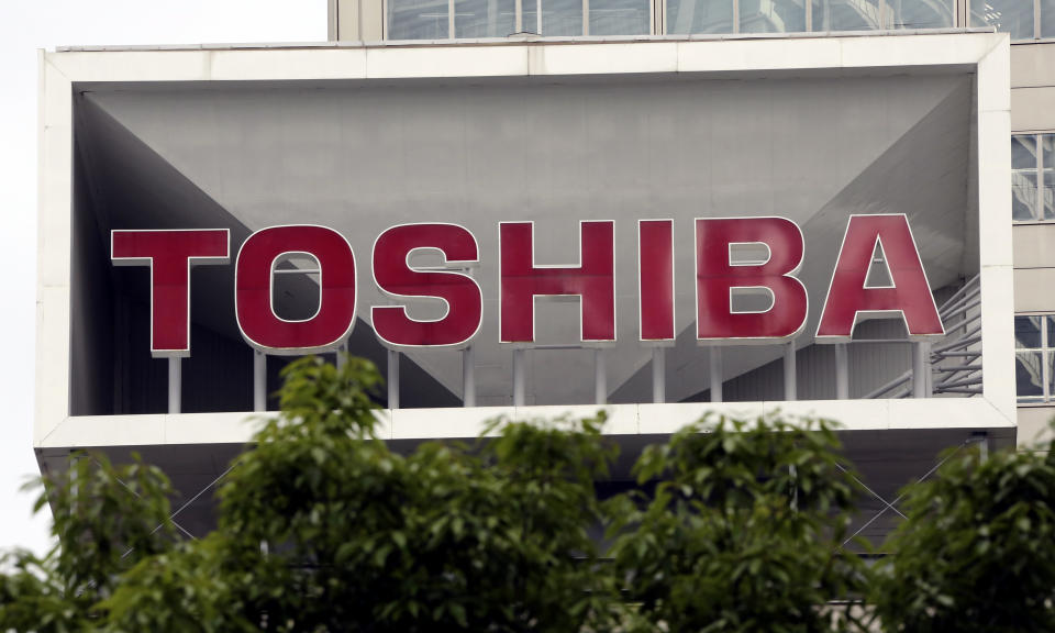 FILE - This May 26, 2017 file photo shows the company logo of Toshiba Corp. displayed in front of its headquarters in Tokyo.Trading in Toshiba stock was halted Wednesday, April 7, 2021 after the Tokyo-based technology conglomerate confirmed it had received a preliminary acquisition proposal. Toshiba Corp. said Tuesday, April 6 it had asked for more details on the proposal, was giving it “careful consideration” and would make an announcement “in due course.” (AP Photo/Koji Sasahara, File)