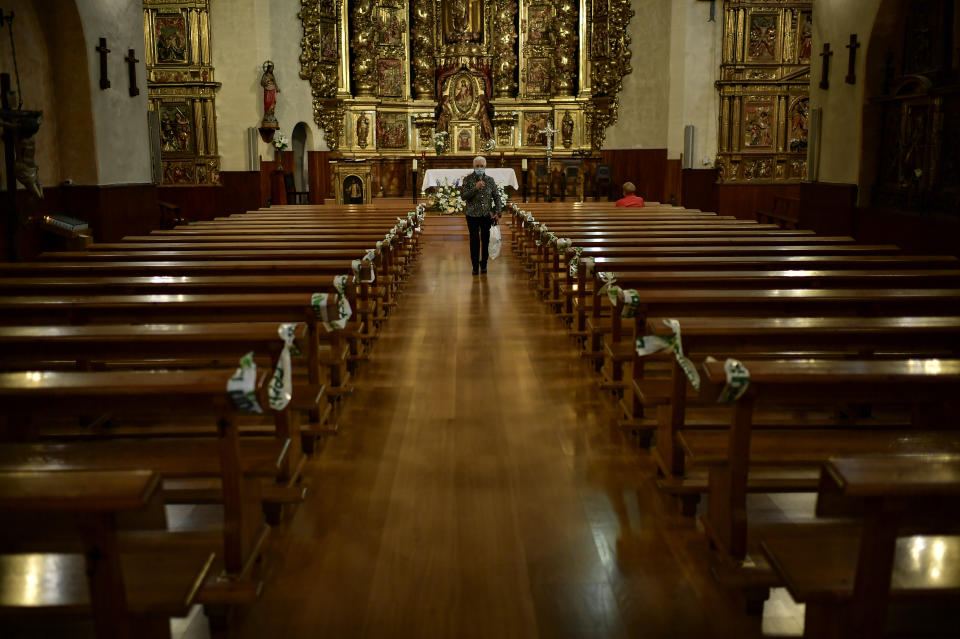 A Devotee wearing a face mask to protect against the coronavirus leaves the church in Lumbier, northern Spain, Sunday, June 7, 2020. The traditional Trinity Pilgrimage was cancelled due to the coronavirus outbreak. (AP Photo/Alvaro Barrientos)