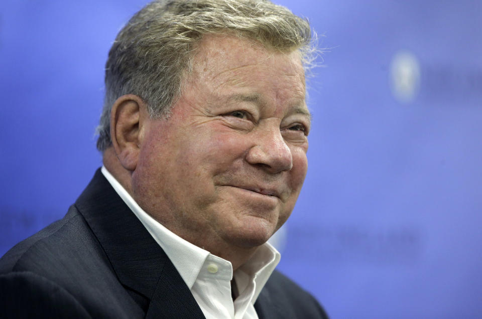 FILE - In this May 6, 2018 file photo, actor William Shatner takes questions from reporters after delivering the commencement address at New England Institute of Technology graduation ceremonies, in Providence, R.I. Star Trek’s Captain Kirk is rocketing into space this month — boldly going where no other sci-fi actors have gone. Jeff Bezos’ space travel company, Blue Origin, announced Monday, Oct. 4, 2021 that Shatner will blast off from West Texas on Oct. 12. (AP Photo/Steven Senne, file)