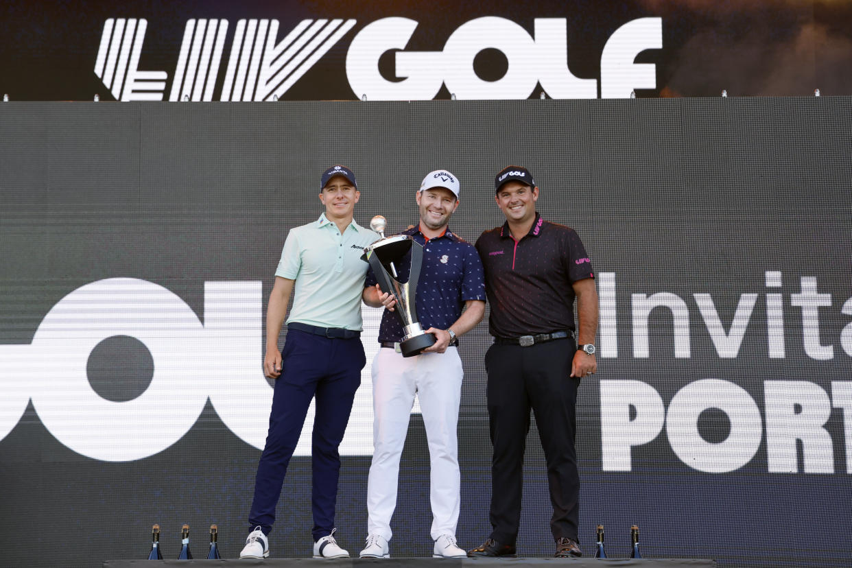 Branden Grace pose with the trophy alongside second place Carlos Ortiz (left) and third place Patrick Reed (right) during the final round of the LIV Golf tournament at Pumpkin Ridge Golf Club on July 2, 2022. Mandatory Credit: Soobum Im-USA TODAY Sports