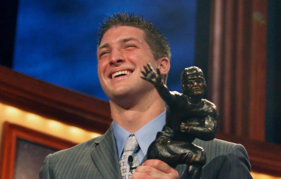 Florida quarterback Tim Tebow holds up the Heisman Trophy after winning the award Saturday, Dec. 8, 2007 in New York.