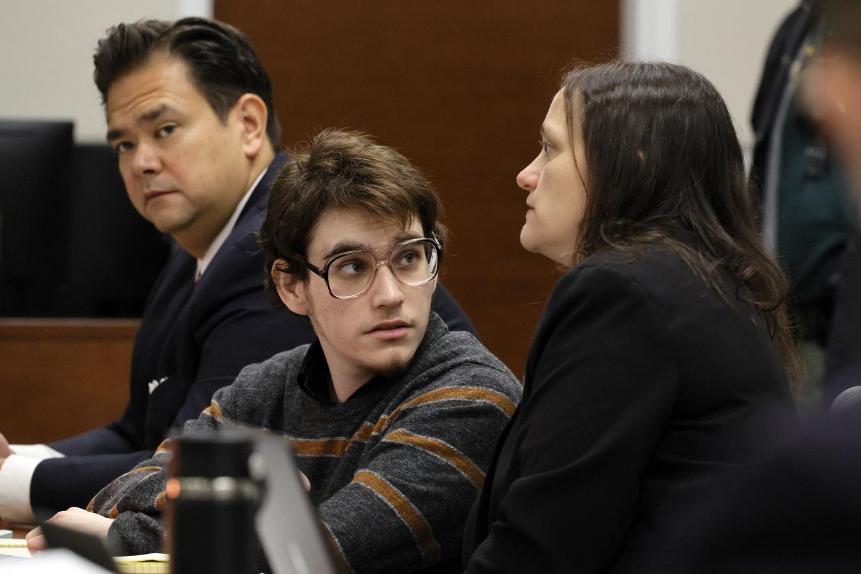 Marjory Stoneman Douglas High School shooter Nikolas Cruz speaks with sentence mitigation specialist Kate O'Shea, a member of the defense team, as Chief Assistant Public Defender David Wheeler is shown at left during jury selection in the penalty phase of his trial at the Broward County Courthouse in Fort Lauderdale on Monday, May 23, 2022. 