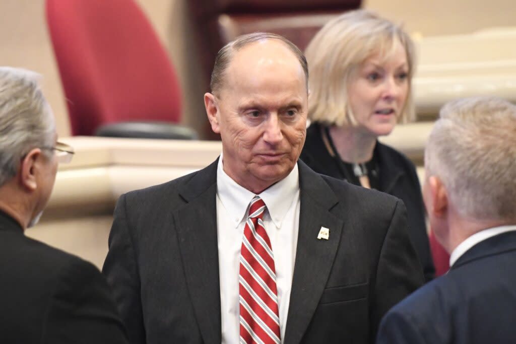 A man in a suit and red and white striped tie