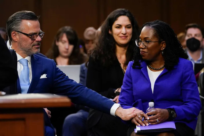 Patrick Jackson reaches over to take his wife’s hand during her confirmation hearing on March 21. Ketanji Jackson said she and her husband have an “unconditional love”—the couple met in college and have been married for 25 years. “I have no doubt that, without him by my side from the very beginning of this incredible professional journey, none of this would have been possible,” Jackson said in her opening statement. “Patrick, I love you.” As she spoke to him, Patrick wiped away a tear.<span class="copyright">Jacquelyn Martin—AP</span>