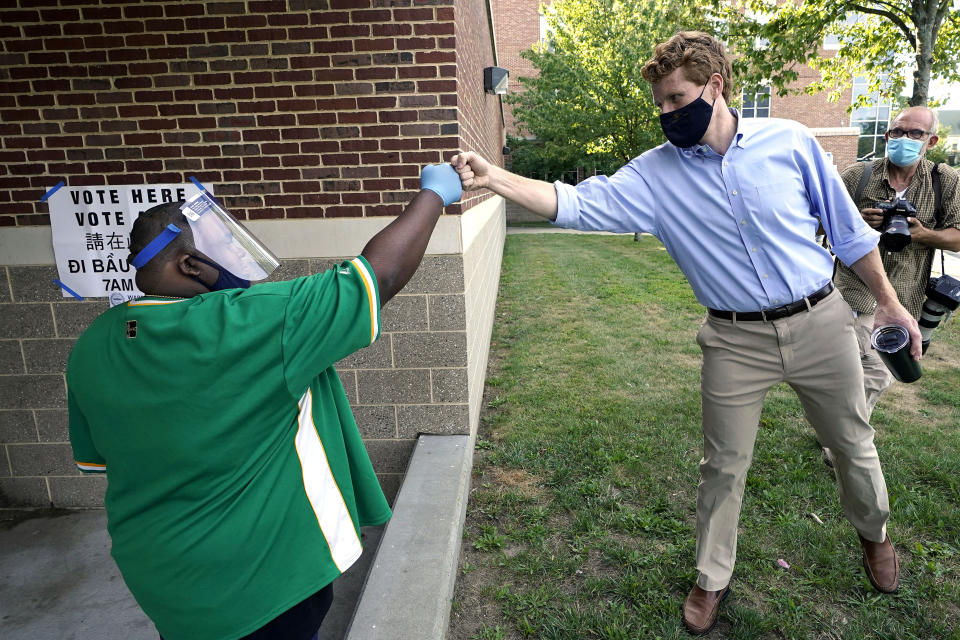 Democratic U.S. Rep. Joe Kennedy III, D-Mass., right, greets James Vines, of Boston, left, during a campaign stop, Tuesday, Sept. 1, 2020, in Boston. Kennedy, a candidate in the Sept. 1 primary election, is challenging incumbent U.S. Sen. Ed Markey, D-Mass., for a seat in the Senate. (AP Photo/Steven Senne)