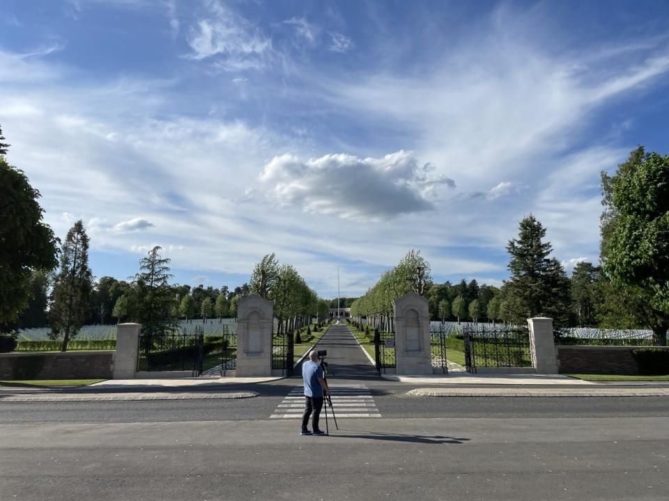 Kaleb Throckmorton, the director of photography for the documentary, takes video of Ouse-Aisne American Cemetery.