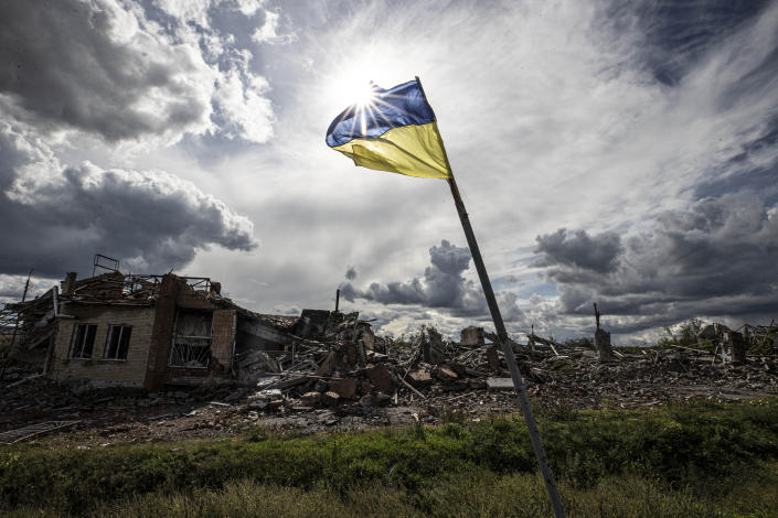 DOLINA, DONETSK, UKRAINE - SEPTEMBER 24: Ukrainian flag waves in a residential area heavily damaged in the village of Dolyna in Donetsk Oblast, Ukraine after the withdrawal of Russian troops on September 24, 2022. Many houses and St. George's Monastery were destroyed in the Russian attacks. Ukraine said on Saturday that its soldiers were entering the city of Lyman in the eastern region of Donetsk, which Russia had annexed a day earlier. (Photo by Metin Aktas/Anadolu Agency via Getty Images)