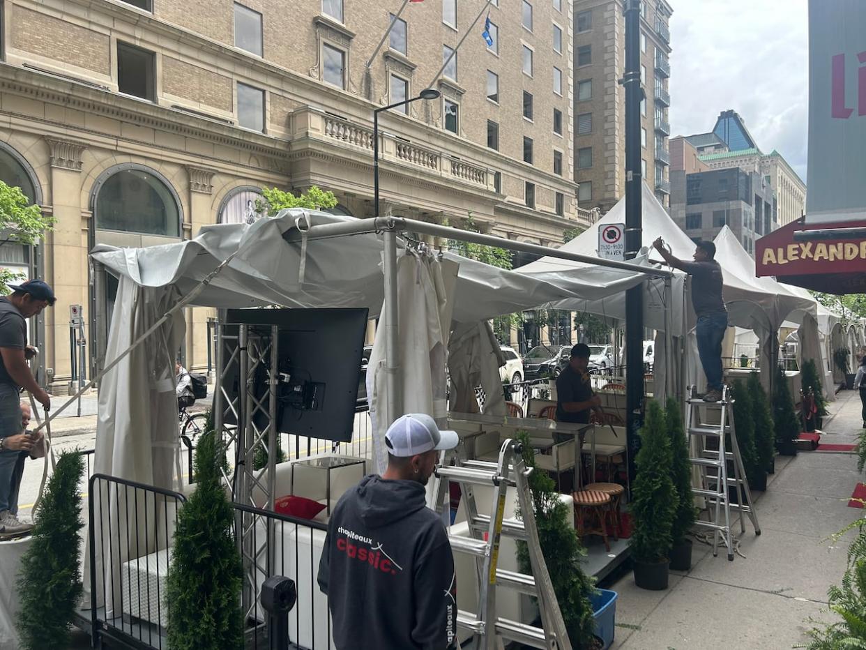 Fire prevention officers said the issue at hand was around the tent tops which are too close to the buildings, making them a fire hazard. (Kwabena Oduro/CBC - image credit)