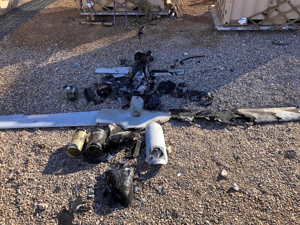 Parts of the wreckage of a drone are laid out on the ground near the Ain al-Asad airbase, in the western Anbar province of Iraq, Tuesday, Jan. 4, 2022. Two explosives-laden drones targeting the base housing U.S. troops were engaged and destroyed by defensive capabilities at the base on Tuesday, a coalition official said. (International Coalition via AP)