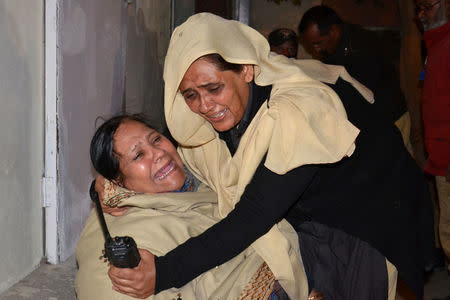 A police officer comforts a relative after a police officer and three of his family members were shot dead in Quetta, Pakistan November 15, 2017. REUTERS/Naseer Ahmed