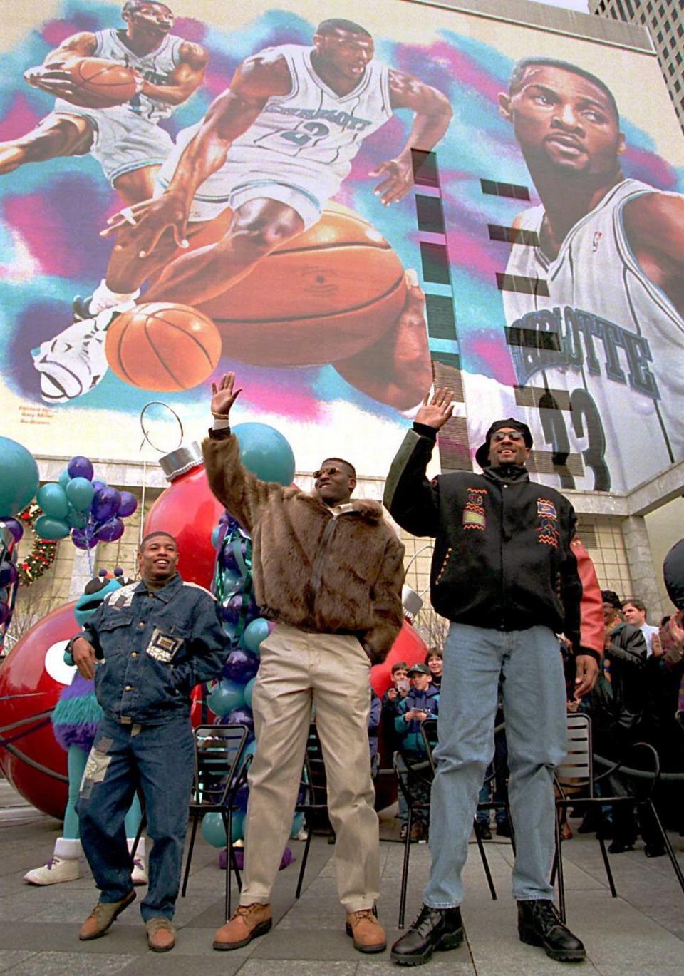 Charlotte Hornets (from left) Muggsy Bogues, Larry Johnson and Alonzo Mourning celebrate the nine-story-high mural depicting them Tuesday, Jan. 3, 1995 in uptown Charlotte.