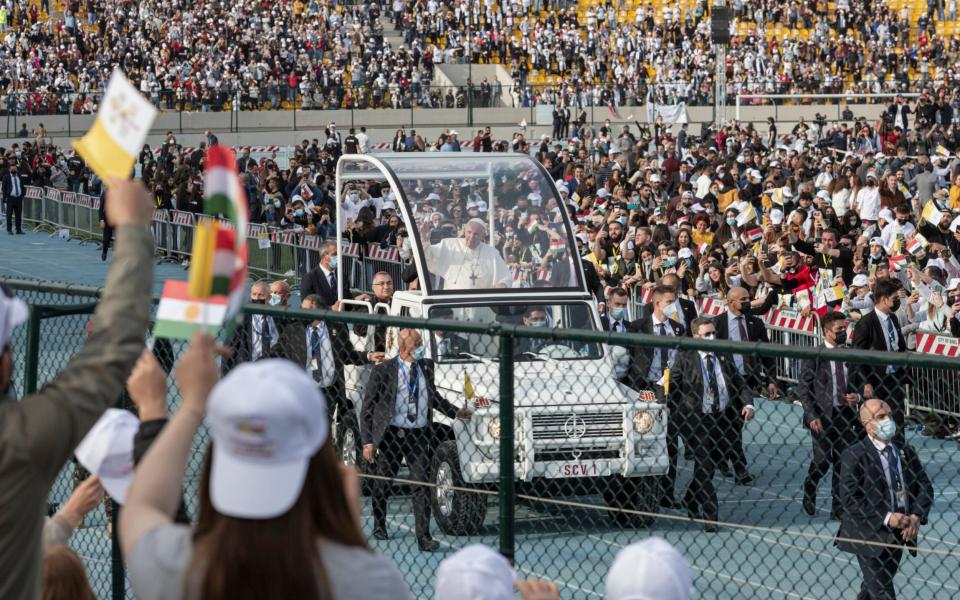 Crowds of some 10,000 people watch Pope Francis arrive at a stadium in Erbil, Iraq - am Tarling for The Telegraph