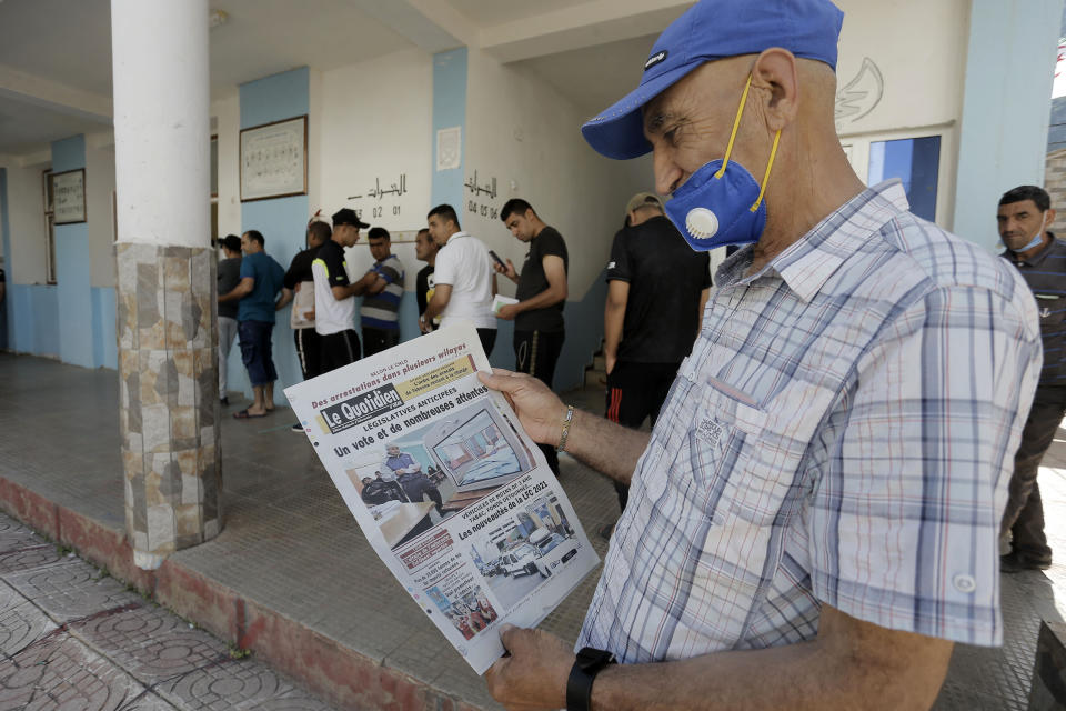 People queue to cast their vote outside a polling station during the country's first legislative elections sine the ouster of ex-president Bouteflika, in Algiers, Algeria, Saturday, June 12, 2021. Algerians vote Saturday for a new parliament in an election with a majority of novice independent candidates running under new rules meant to satisfy demands of pro-democracy protesters and open the way to a "new Algeria." (AP Photo/Toufik Doudou)