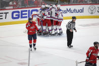 New York Rangers players celebrate after defeating the Washington Capitals during the third period in Game 4 of an NHL hockey Stanley Cup first-round playoff series, Sunday, April 28, 2024, in Washington. (AP Photo/Tom Brenner)