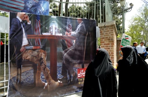 Iranians take part in an anti-US demonstration inside the former embassy headquarters in Tehran on May 16, 2018