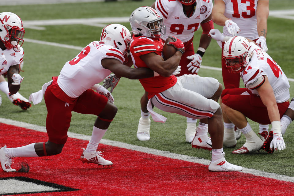 Ohio State running back Master Teague, right, spins into the end zone against Nebraska defensive back Marquel Dismuke during the first half of an NCAA college football game Saturday, Oct. 24, 2020, in Columbus, Ohio. (AP Photo/Jay LaPrete)