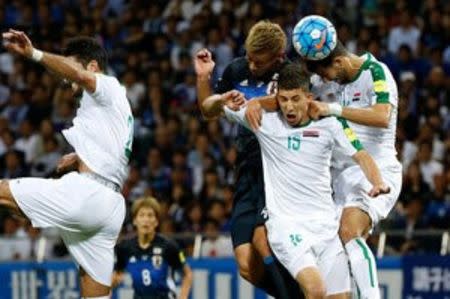 Football Soccer - Japan v Iraq - World Cup 2018 Qualifier - Saitama Stadium 2002, Saitama, Japan - 6/10/16. Japan's Keisuke Honda (C), Iraq's Ahmed Ibrahim (L), Dhurgham Ismael (15), Suad Natiq Naji in action. REUTERS/Issei Kato