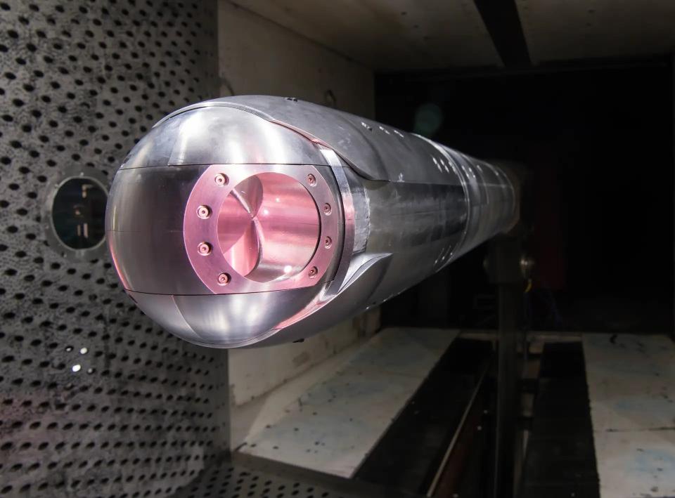A wind tunnel model of a laser directed energy weapon turret like one would have expected to see as part of the SHiELD design, with simulated laser 'glow', during setting at Arnold Air Force Base in Tennessee in 2021. U.S. Air Force/Jill Pickett