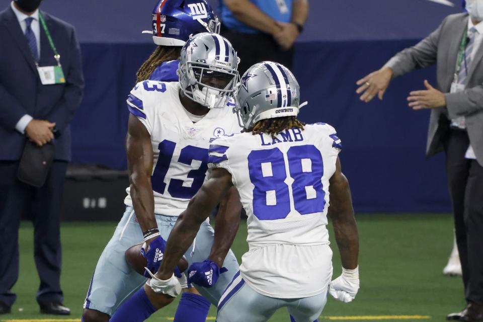 Dallas Cowboys' Michael Gallup (13) and CeeDee Lamb (88) celebrate a catch by Gallup in the second half of an NFL football game against the New York Giants in Arlington, Texas, Sunday, Oct. 11, 2020. (AP Photo/Ron Jenkins)