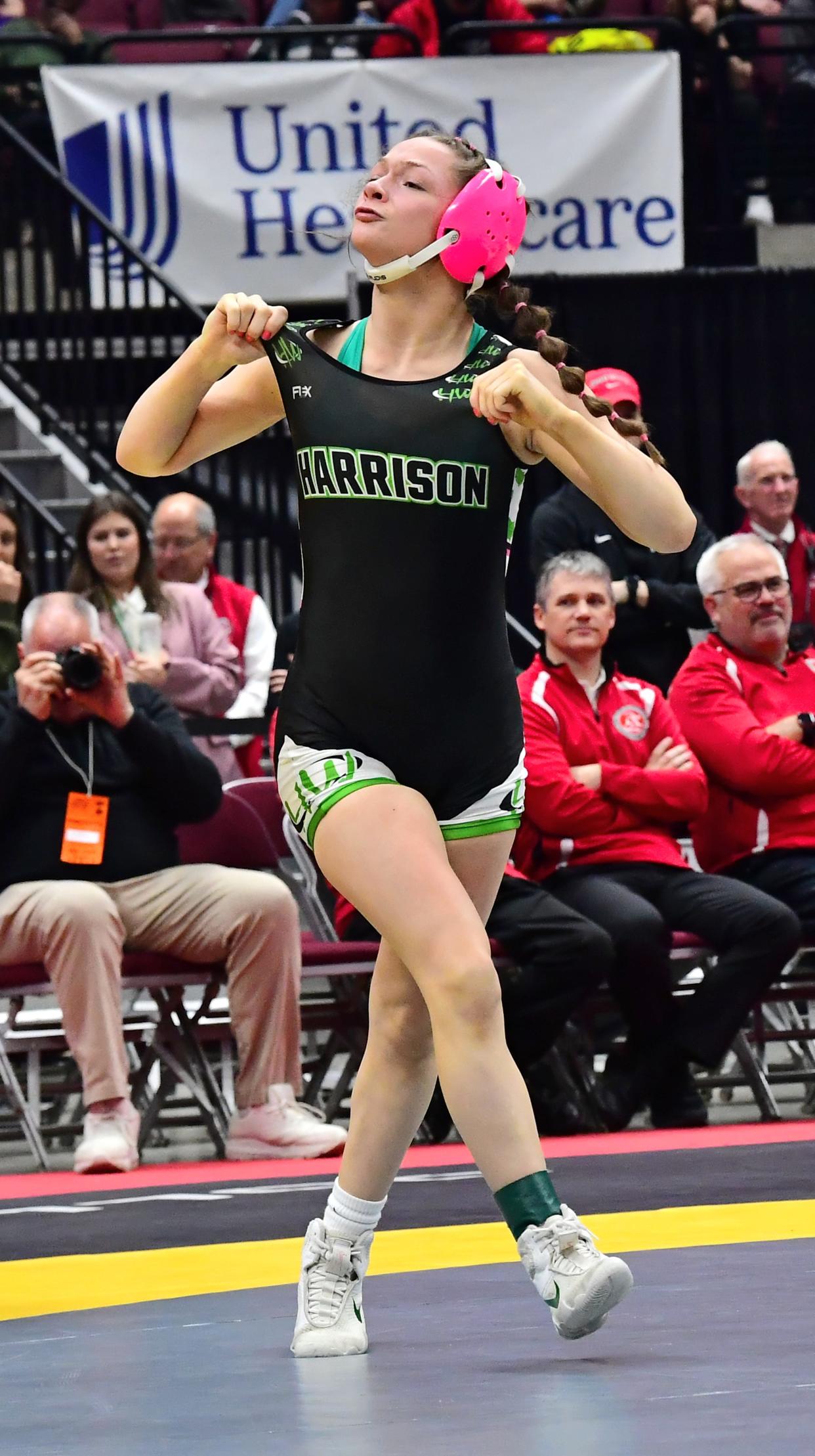 Harrison's Chloe Dearwester celebrates her championship at 105 pounds during the OHSAA inaugural girls wrestling state tournament, March 10-12, 2023.