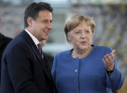 FILE - In this Tuesday, Nov. 19, 2019 file photo, German Chancellor Angela Merkel, right, and Italy's Prime Minister Giuseppe Conte, left, shake hands prior to a meeting at the chancellery as part of the 'Compact with Africa' conference in Berlin, Germany. When Giuseppe Conte exited the premier’s office, palace employees warmly applauded in him appreciation. But that’s hardly likely to be Conte’s last hurrah in politics. Just a few hours after the handover-ceremony to transfer power to Mario Draghi, the former European Central Bank chief now tasked with leading Italy in the pandemic, Conte dashed off a thank-you note to citizens that sounded more like an ’’arrivederci″ (see you again) then a retreat from the political world he was unexpectedly propelled into in 2018.(AP Photo/Michael Sohn, File)