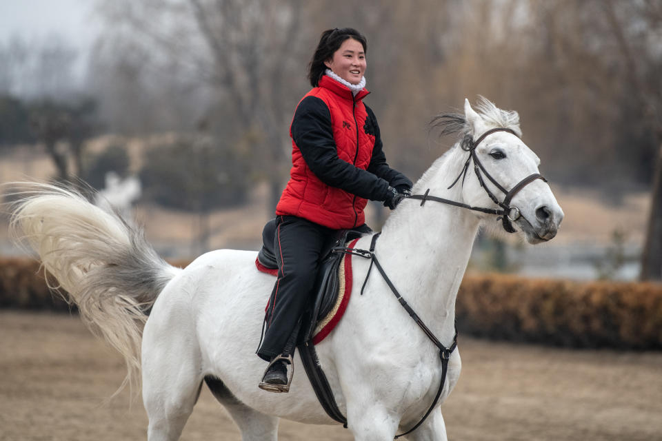 A horseback riding instructor gallops during a break between lessons at Myrim Riding Club on Feb. 6, in Pyongyang.