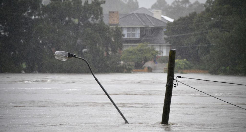 A street light pole under floodwaters along the overflowing Nepean river in Penrith suburb on March 21, 2021.