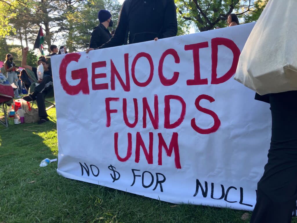 A large banner reads "Genocide Funds UNM. No money for nuclear."