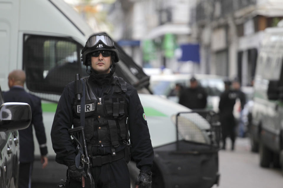 Algerian security forces guard the courtroom as former Algerian Prime Ministers Ahmed Ouyahia and Abdelmalek Sellal face corruption charges, Wednesday, Dec.4, 2019 in Algiers. Ahmed Ouyahia, who was forced out as prime minister in March as protests against President Abdelaziz Bouteflika escalated, and his predecessor Abdelmalek Sellal, are facing questions Wednesday at the Sidi M'Hamed court in Algiers. (AP Photo/Toufik Doudou)